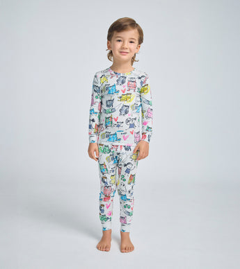 Child wearing The Color Monster inspired pajamas with playful monster illustrations