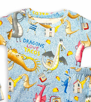 Close-up of pajama top with dragons, tacos, and colorful story-themed print