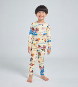 Smiling child wearing Little Blue Truck kids pajama set with farm animal designs