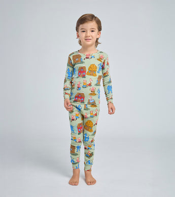 Child wearing Three Little Pigs pajama set with storybook characters