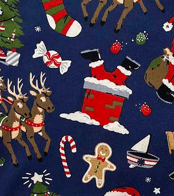 Detail of pajama fabric showing Santa in chimney and gingerbread cookie