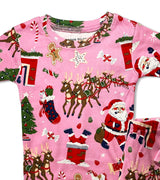 Close-up of pink pajama top featuring Santa, reindeer, and stockings