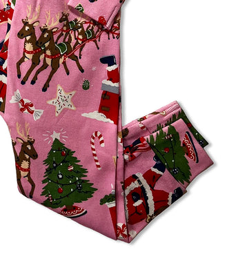 Pajama pants detail with Christmas trees and Santa print on pink fabric