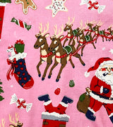 Detail of reindeer, Santa, and candy illustrations on pink kids pajamas