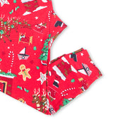 Red pajama pants with festive Christmas patterns including stockings and reindeer