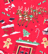 Detail of red pajamas featuring reindeer, gingerbread, and candy cane prints