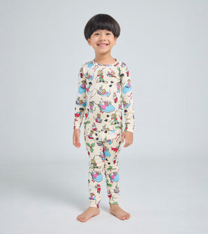 Child wearing Santa Mouse pajamas with festive mouse illustrations