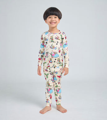 Child wearing Santa Mouse pajamas with festive mouse illustrations
