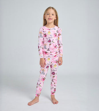 Child wearing pink Twinkle fairy pajama set with playful storybook print