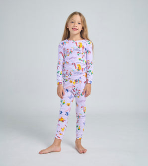 Child wearing Uni the Unicorn pajama set with playful unicorn design