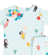 Close-up of pajama top and pants featuring children and balloons in soft watercolor style
