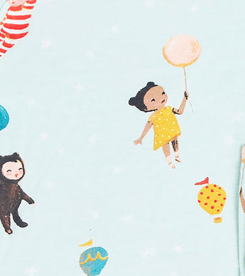 Close-up of pajama print showing a child in yellow holding a balloon