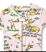 Close-up of pink baby coverall featuring bunnies and story-inspired print