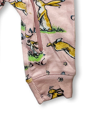 Lower part of pink coverall showing bunny and butterfly designs