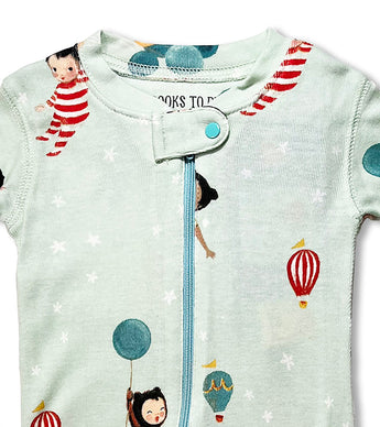 Close-up of baby coverall neckline with playful storybook characters and balloons