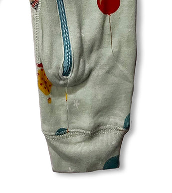 Leg and zipper detail of baby coverall with colorful balloon print