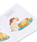 Inside page of 'Good Night, Biscuit' book showing a girl tucking Biscuit the puppy into bed