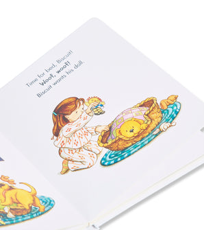Inside page of 'Good Night, Biscuit' book showing a girl tucking Biscuit the puppy into bed
