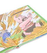 Inside page of The Three Little Pigs book showing a pig running from a straw house