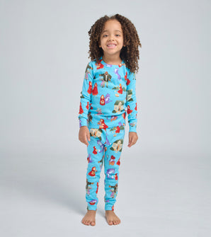 Child wearing Little Red Riding Hood pajamas, smiling and standing