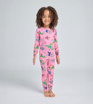Child wearing pink Pete the Cat pajama set with cupcake and animal print