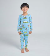 Child wearing blue Rocket dog print pajamas, smiling