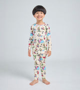 Child wearing Santa Mouse pajamas with allover mouse and holiday print