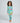 Child wearing dinosaur print pajamas from Tiny T. Rex and the Impossible Hug set