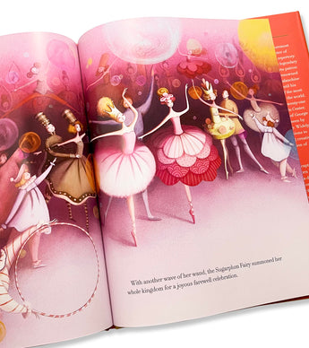 Open page from The Nutcracker book with colorful ballet illustrations.