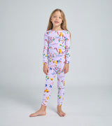 Child wearing Uni the Unicorn baby pajama set, smiling
